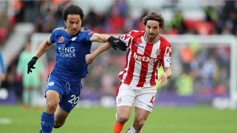 Shinji Okazaki and Joe Allen battle for possession at the Bet365 Stadium