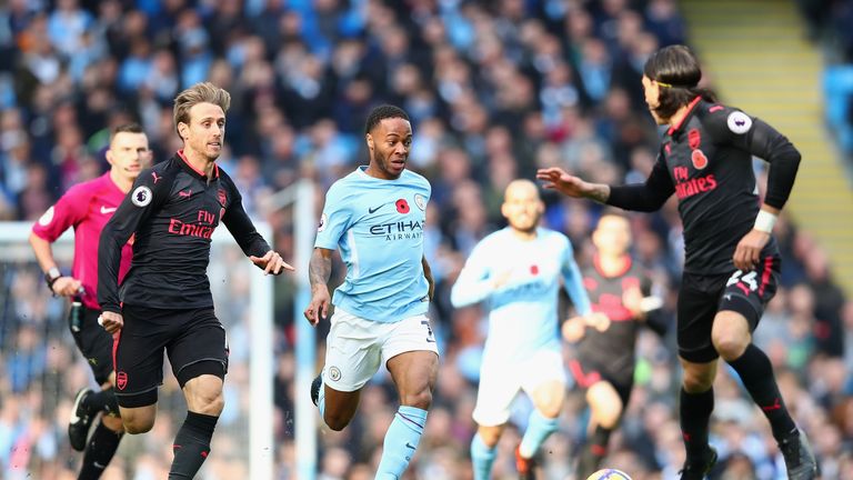 Raheem Sterling battles for possession in the first half