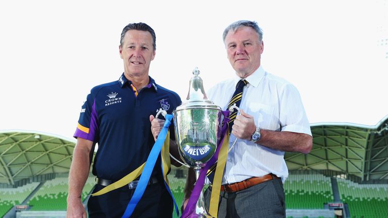 Melbourne head coach Craig Bellamy (left) and Gary Hetherington pose with the World Club Challenge trophy
