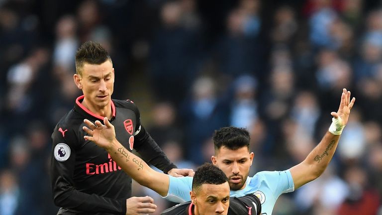 Francis Coquelin is put under pressure by Sergio Aguero