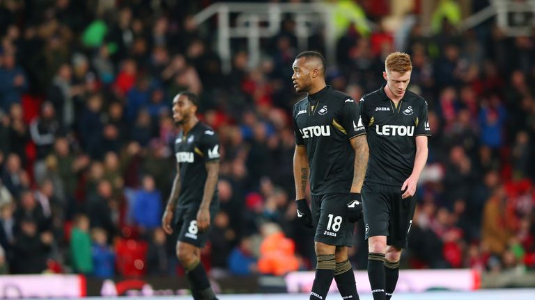 Swansea City players look dejected during their 2-1 defeat at Stoke City