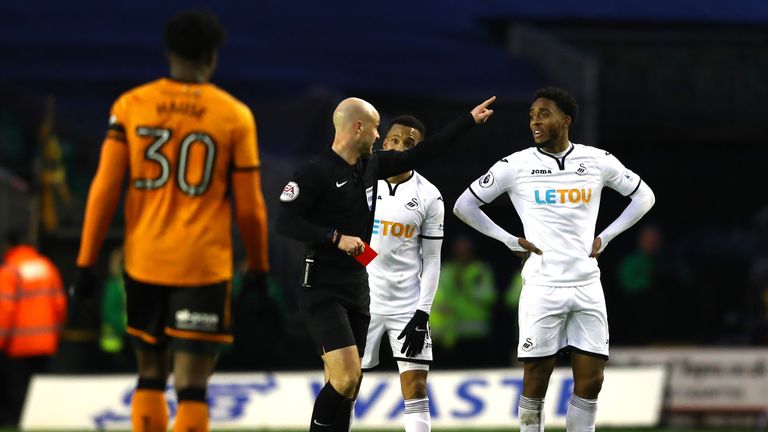 Leroy Fer of Swansea City is shown the red card from referee Anthony Taylor