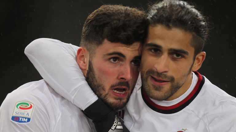 Patrick Cutrone (L) celebrates after scoring the opening goal for AC Milan