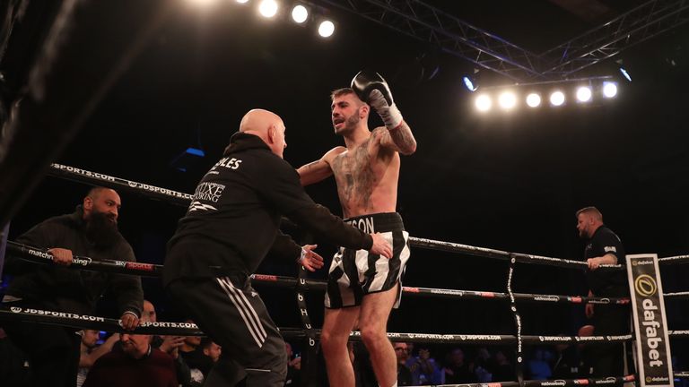 The champion celebrates his swift stoppage win over Joe Murray