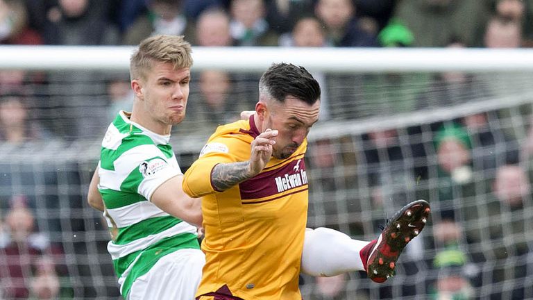 Celtic's Kristoffer Ajer and Motherwell's Ryan Bowman battle for the ball.