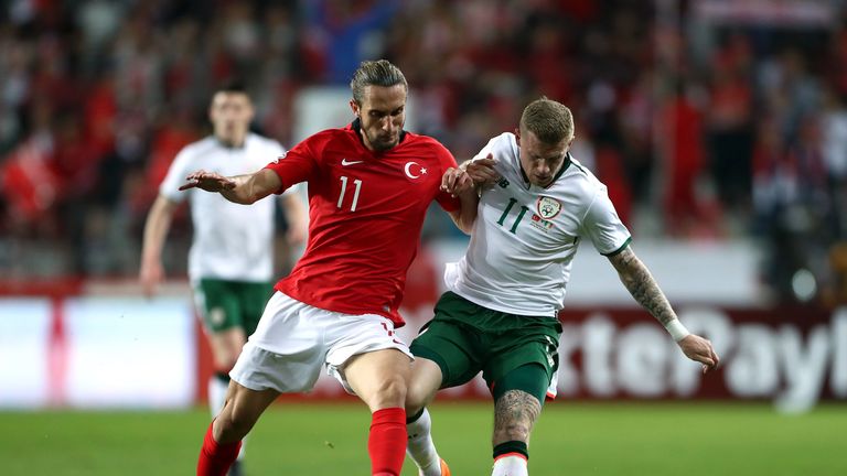 Yusuf Yazici and James McClean tussle in the middle of the park