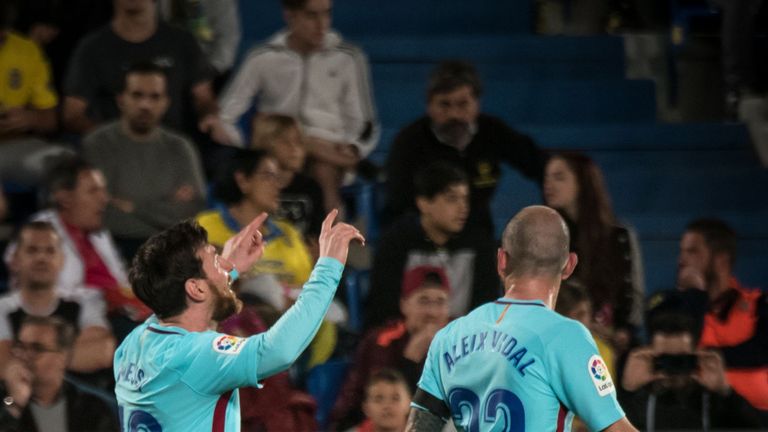 Lionel Messi celebrates with team-mate Aleix Vidal after giving Barcelona the lead at Las Palmas