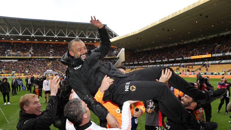 Nuno Espírito Santo is carried across the pitch during celebrations at Molineux