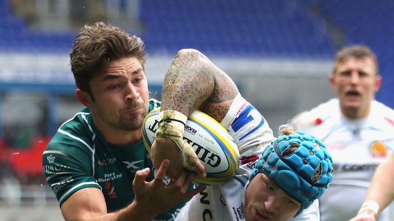 Jack Nowell looks to keep hold of possession after a tackle by Tom Fowlie