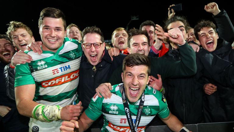 Benetton's Sebastian Negri and Tommaso Allan celebrate with fans after a sensational victory over Leinster in Dublin