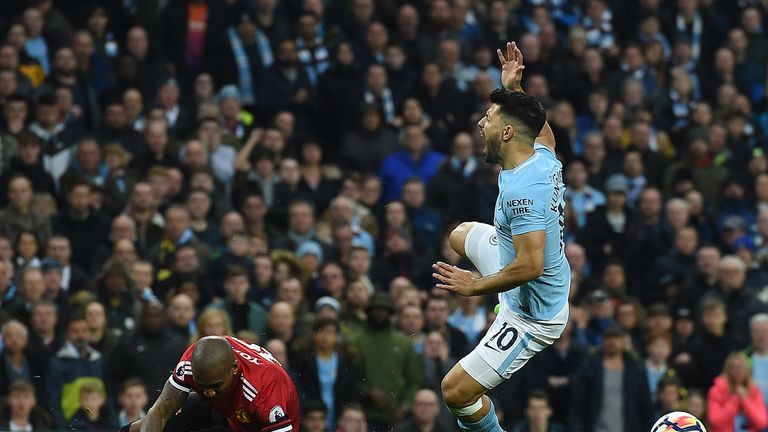 Aguero is tackled by Manchester United's Ashley Young