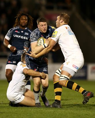Sam James of Sale is tackled by Jimmy Gopperth and Joe Launchbury of Wasps