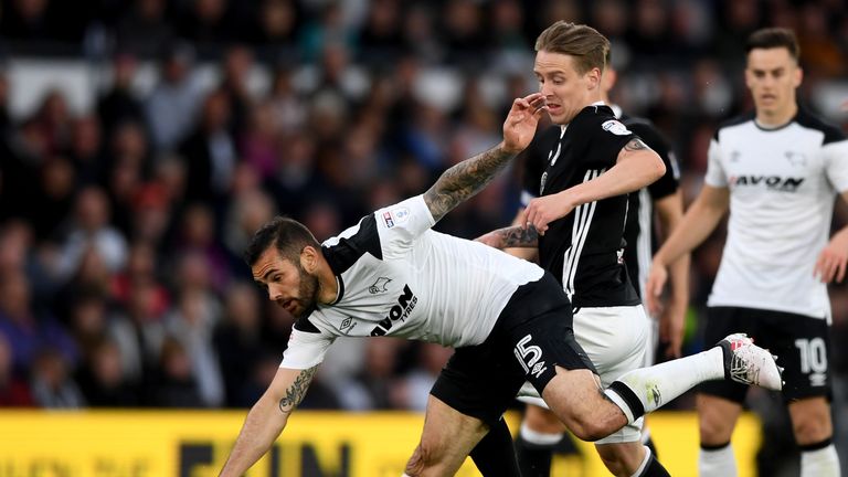 Bradley Johnson is challenged by Stefan Johansen