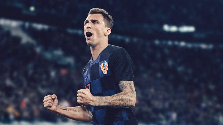 Mario Mandzukic sports Croatia's away shirt which combines black and blue checkerboard