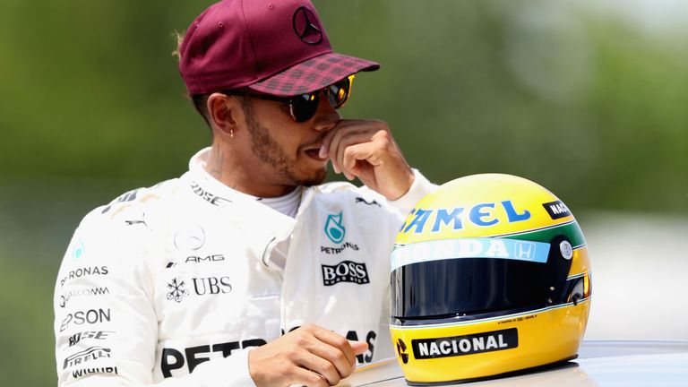 Hamilton with a replica Ayrton Senna helmet, presented to him in Canada last year after he matched his idol's tally of 65 poles