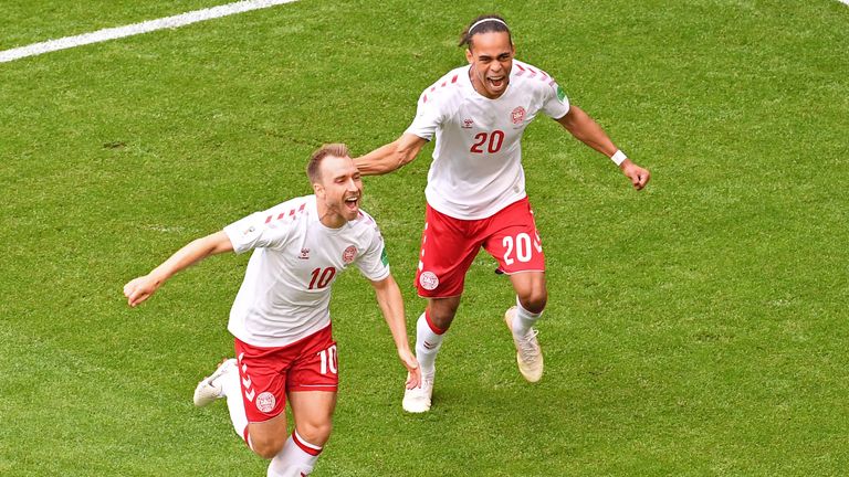 Christian Eriksen celebrates with Denmark's Yussuf Poulsen