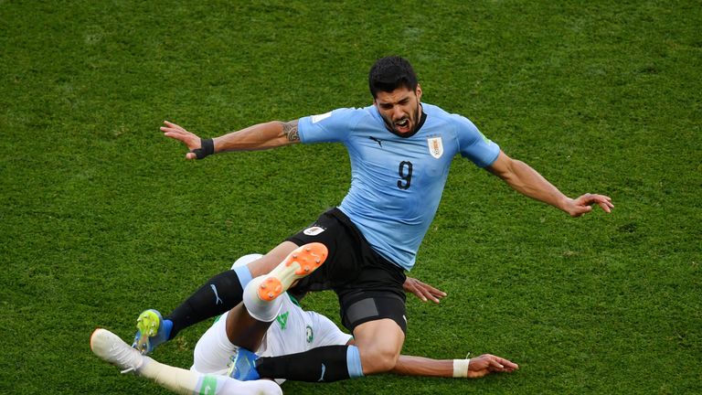 Luis Suarez is tackled by Ali Albulayhi during the first-half at Rostov Arena