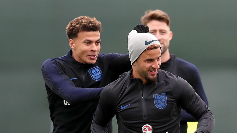 Alli jokes with Kyle Walker during an England training session