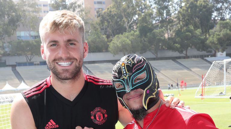  Luke Shaw of Manchester United shakes hands hand with Mysterio 