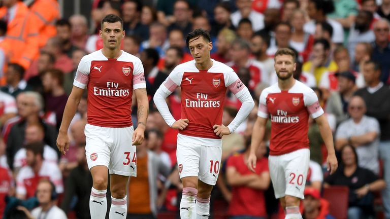 Arsenal's Granit Xhaka, Mesut Ozil and Shkodran Mustafi look on during the 2-0 home defeat to Manchester City