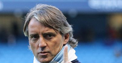Equipped with his traditional striped scarf - as seen during his time at Inter - Roberto Mancini takes charge of his first game for Man City against Stoke.