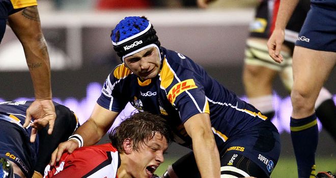 Michael Rhodes stretches over to score