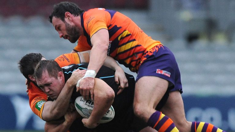 The Widnes defence wraps up Broncos' Scott Wheeldon