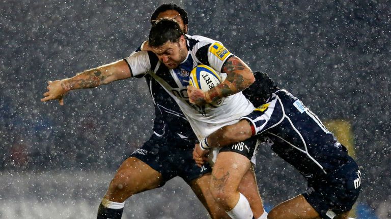 Matt Banahan is brought down by two Sale tacklers