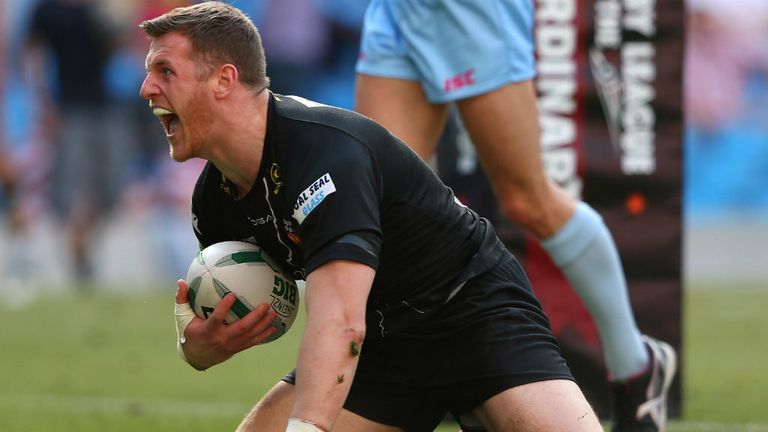 Larne Patrick celebrates his try for Huddersfield