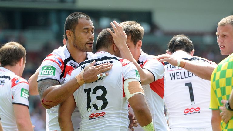 Willie Manu is congratulated by St Helens team-mates after scoring his try