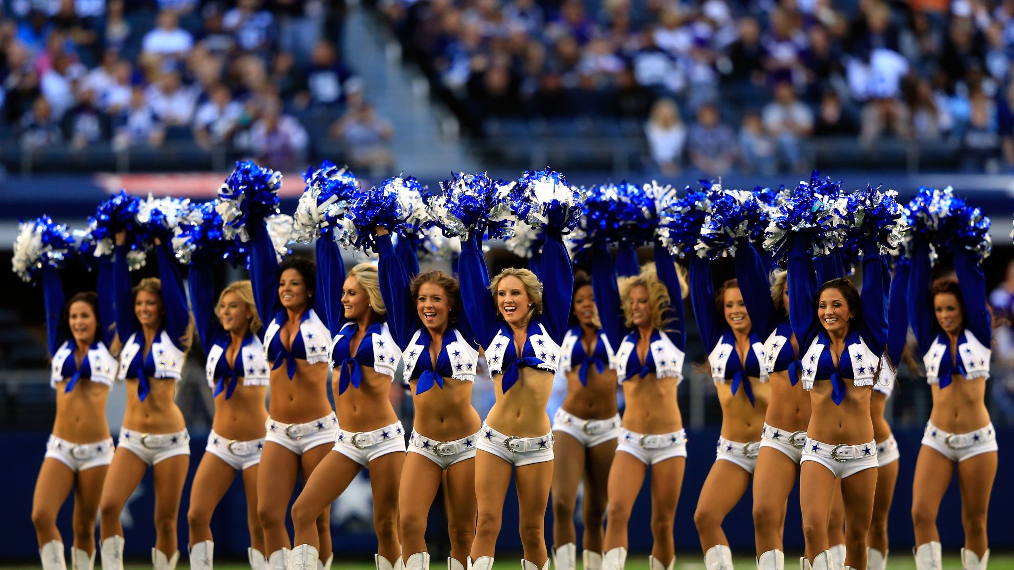 This Dallas Cowboys Cheerleader, Angela (the team does not publicize the  last names of its cheerleading squad members), and about 35 others,  entertain the crowd at a National Football League game at