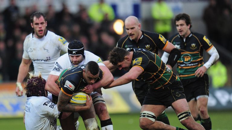 Courtney Lawes is tackled by Oliver Tomaszczyk and Fraser McKenzie