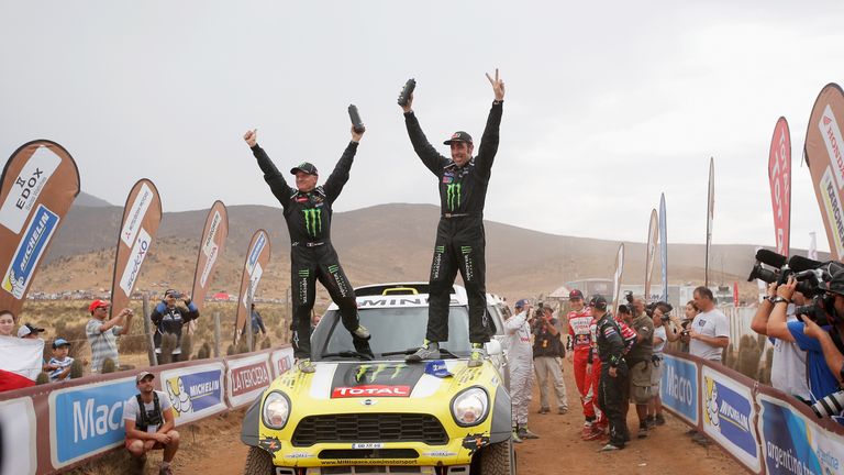 Nani Roma (R) and co-driver Michel Perin celebrate victory in the Dakar Rally