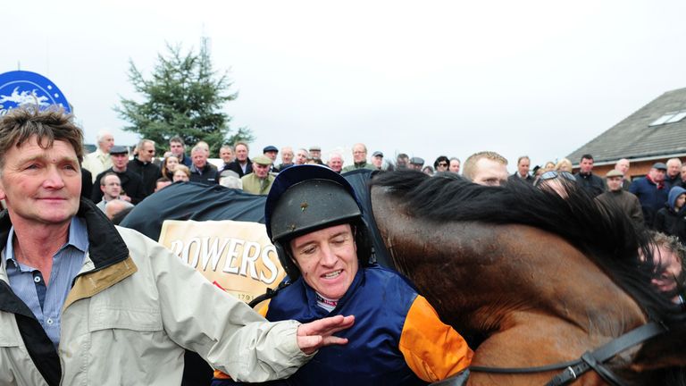Barry Geraghty and Rebel Fitz enjoy a post-victory wrestle in the winner's enclosure.