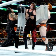 Roman Reigns and Sheamus sandwich Kane during the main-event Ladder Match