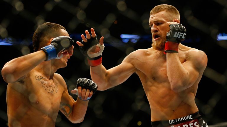Conor McGregor (R) takes on Max Holloway