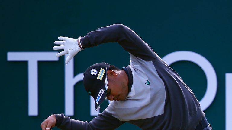 Twist and Shout: Yusaku Miyazato of Japan stretches on the first tee. Can he name The Beatles?