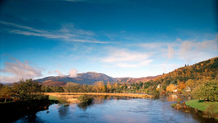 Looking across the river Teith to houses with the hills beyond, at Callander, Stirling.