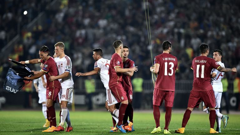 Serbia and Albania players scuffle over the flag