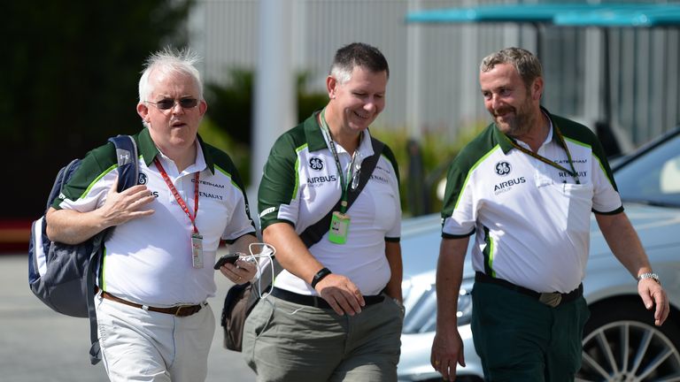Caterham administrator and interim team boss Finbarr O&#191;Connell (L) makes his way into the Abu Dhabi paddock