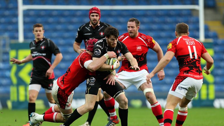 Shane Monahan of Gloucester is tackled by James Down of London Welsh