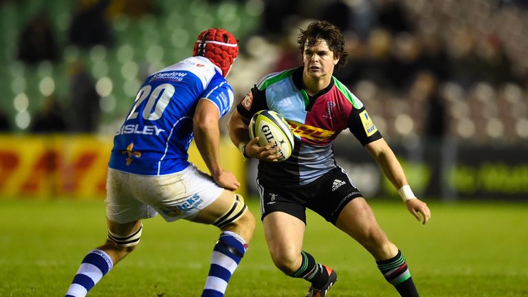 Fly-half Tim Swiel of Harlequins is challenged by Ollie Griffiths of Dragons
