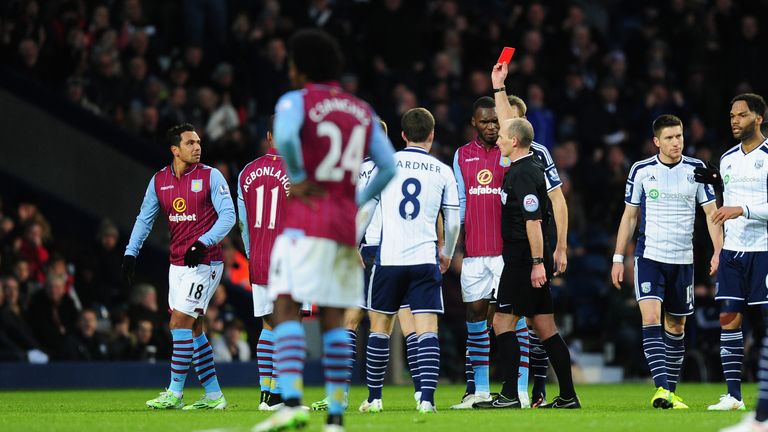 Mike Dean shows Kieran Richardson a straight red card for his tackle on Stephane Sessegnon.