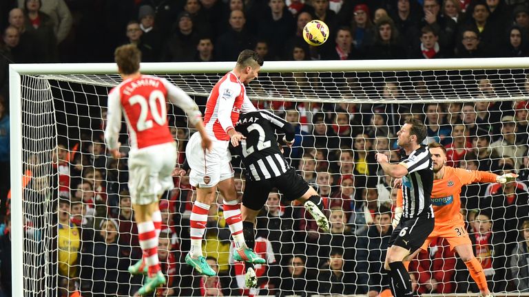 Olivier Giroud rises highest to score the opening goal.