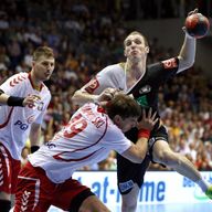 Holger Glandorf (R) of Germany is challenged by Piotr Chrapkowsk and Piotr Grabarczykof Poland 