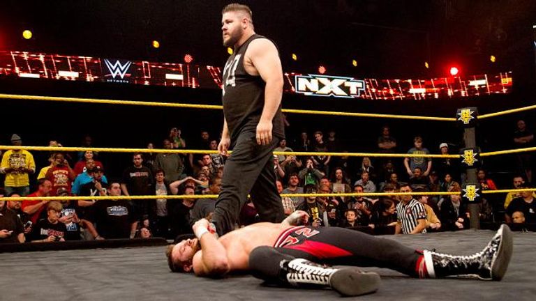 Kevin Owens stands over his victim, Sami Zayn