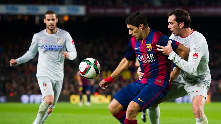 Luis Suarez fights for the ball with Diego Godin
