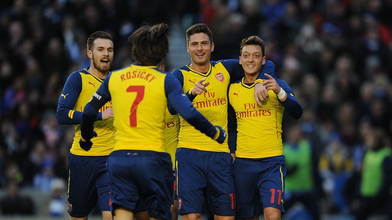 Mesut Ozil: Celebrates with his team-mates after scoring Arsenal's second goal.