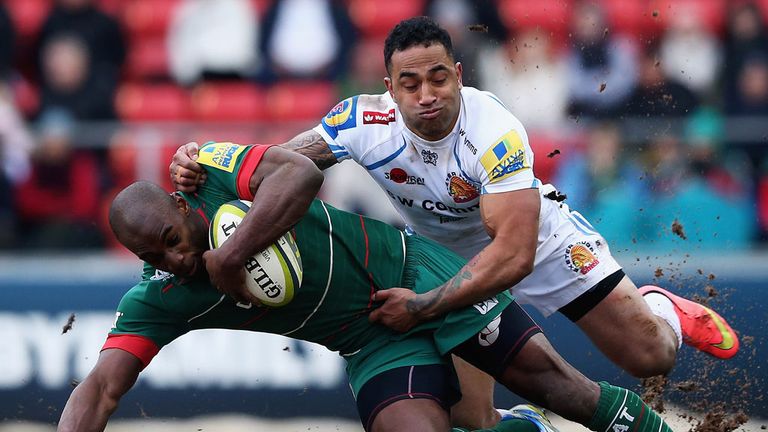 Miles Benjamin of Leicester Tigers is tackled by Fetuu Vainikolo of Exeter Chiefs