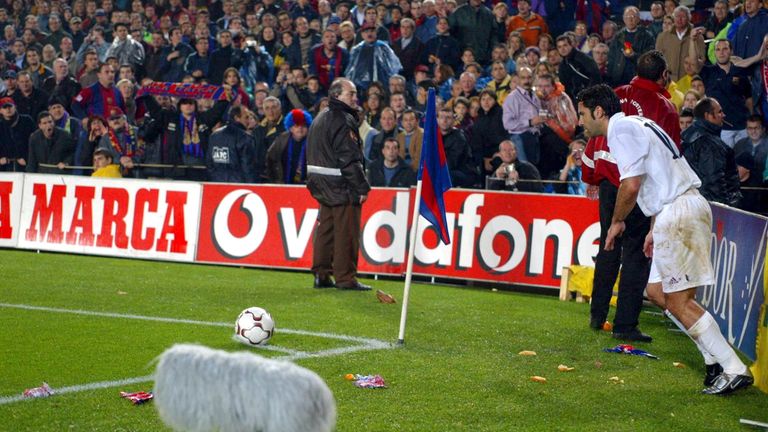 Figo is pelted with missiles as he attempts to take a corner at the Nou Camp